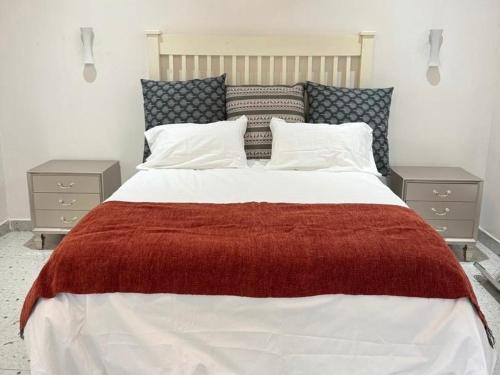 a bedroom with a large bed with two night stands at The Snug Spot in Lusaka