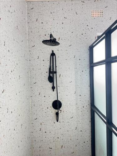 a light hanging from a wall with a ceiling at The Snug Spot in Lusaka