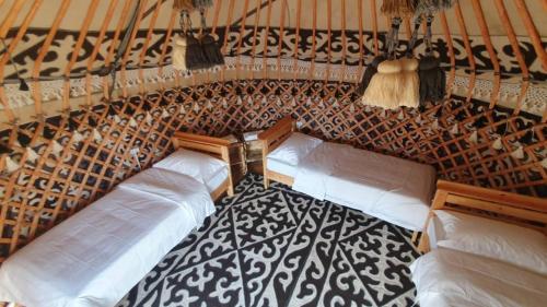 a room with four pillows in a room with a wall at Elizabet guest house in Kerben