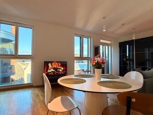 a living room with a table and a fireplace at Luxury Suites Rotermanni 5 by Rikas Hotels in Tallinn