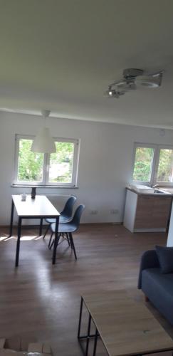 a living room with a blue couch and a table at Bobrowe Zacisze in Wleń