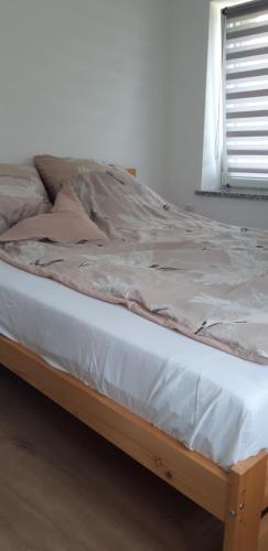a bed in a room with a wooden frame at Bobrowe Zacisze in Wleń