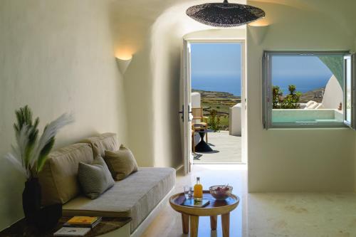 a living room with a couch and a table at Avelora Suites in Pyrgos