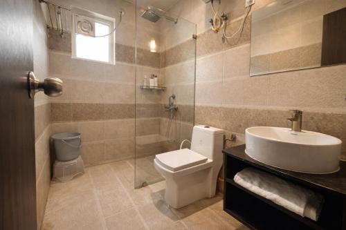 a bathroom with a toilet and a sink and a shower at Onyx Suite Luxury Apartment # Lift # Garden # Ac rooms # Private Parking # Near Prem Mandir # Located Inside- Omaxe Eternity Vrindavan # in Vrindāvan