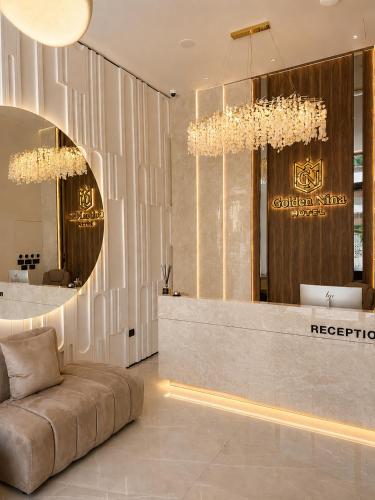 a lobby with a couch and a reception desk at Golden Nina Hotel in Vlorë