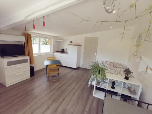a living room with a kitchen and a dining room at Omnia in Saint-Maixent-lʼÉcole