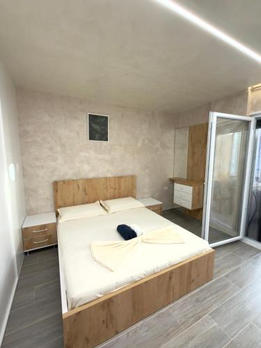 a large bed in a room with a mirror at Apart-Hotel Suites - Qerret, Golem, Durres in Golem