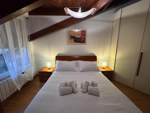 a bedroom with a bed with two towels on it at L'Archè - The Rustic Loft in Cinisello Balsamo