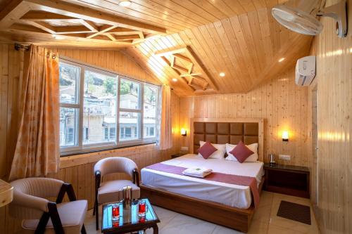 a bedroom with a bed in a room with wooden walls at Royal Nest in Kasauli