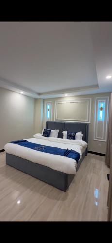 a bedroom with a large bed with blue and white pillows at Seven sky hotel in Murree