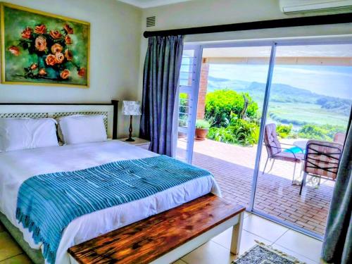 a bedroom with a bed and a sliding glass door at Lagoon Lodge in Freeland Park