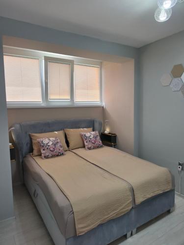 a bed in a bedroom with two pillows on it at Апартамент Туида 2 in Sliven