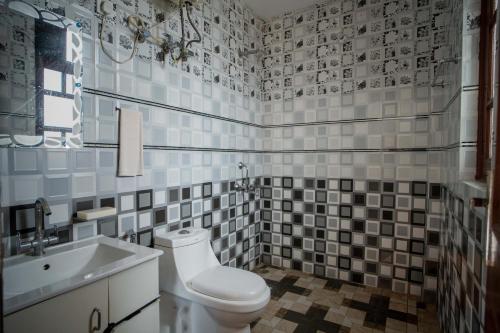 a bathroom with a toilet and a sink at Royal Nest in Kasauli