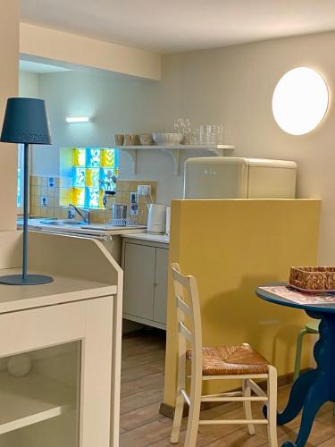 a kitchen with a counter and a table with a chair at Apartments Olga in Bled