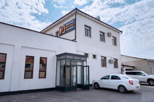 a white building with a phone booth in front of it at BESQALA in Nukus