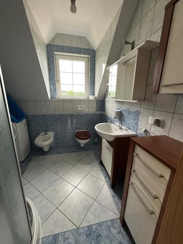 a bathroom with a sink and a toilet at Willa nad stawem in Mezowo
