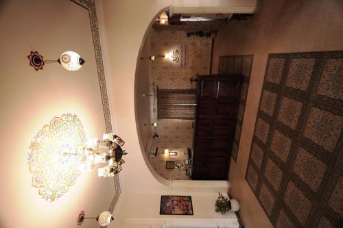 a bathroom with a mirror and a chandelier at Rangmahal Pushkar by DIV HOSPITALITY in Pushkar
