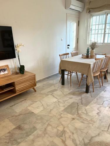 a living room with a table and a tv at Casa Quijote in La Herradura