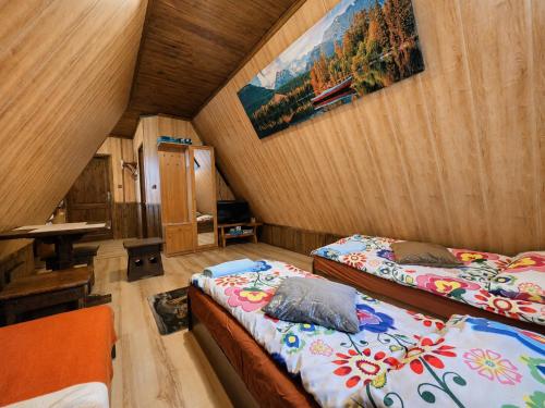 a room with two beds and a table in it at Noclegi u Marka in Czernichów