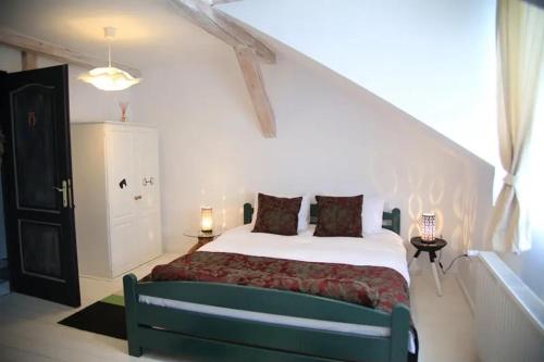 a bedroom with a bed in a white room at Cross Country Farm in Prod
