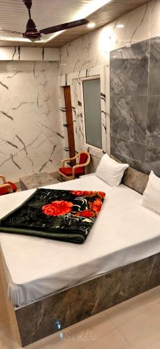 a bedroom with a bed with a blanket on it at Hotel Siddhant in Pithorāgarh