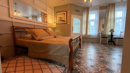 a bedroom with a bed and a desk in a room at Venezia in Haapsalu