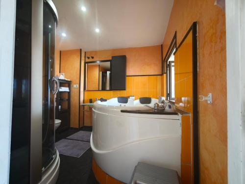 a bathroom with a large tub and a sink at Vistas de Ronda in Ronda