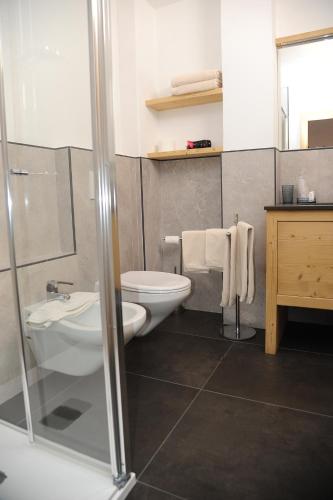 a bathroom with a toilet and a sink at B&B Seppi in Cavalese