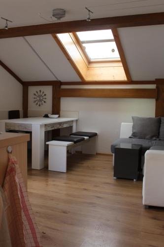 a attic room with a bed and a skylight at Gästehaus Hanser in Virgen