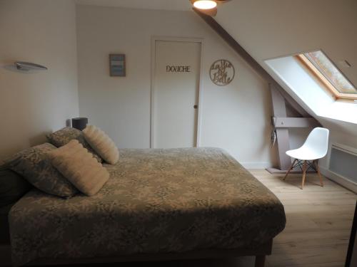 a bedroom with a bed and a staircase with a door at Chambre d'hôte Monthorin in Vernie