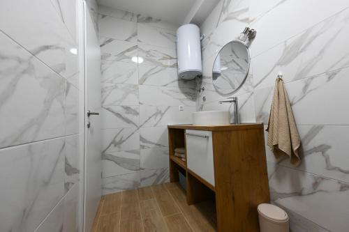 a bathroom with a sink and a mirror at Apartment Sanja in Zadar