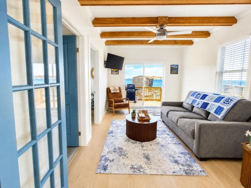 a living room with a couch and a table at Wild Cove Nook in Twillingate