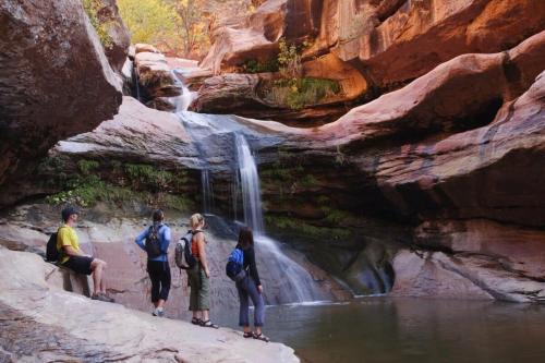 a group of people standing in front of a waterfall at 406 Canyon Rd #1 in Ogden