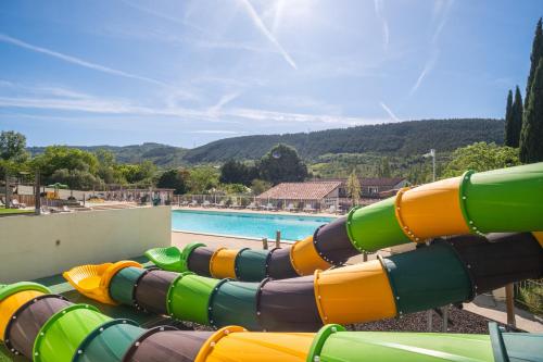 a water slide in front of a swimming pool at Ludocamping in Lussas