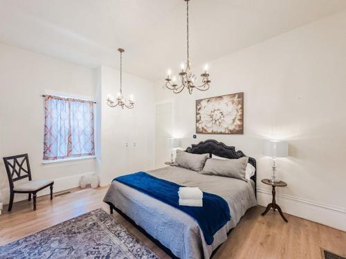 a bedroom with a bed and a chandelier at 406 Canyon Rd #2 in Ogden