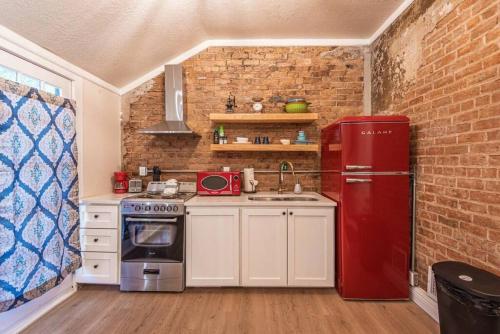 a kitchen with a red refrigerator and a sink at 406 Canyon Rd #2 in Ogden