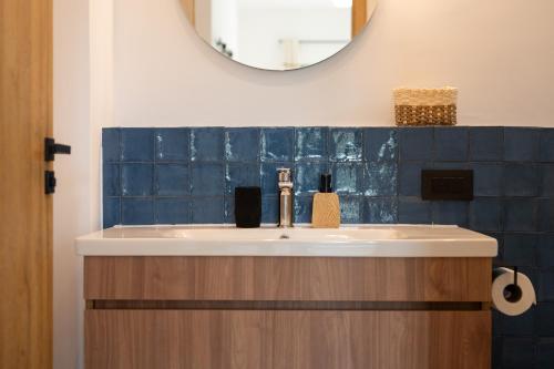 a bathroom with a sink and a mirror at Asini deluxe suite 5, with rooftop terrace and breathtaking views in Asíni