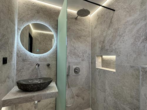 a bathroom with a sink and a shower at ANNA ROOMS (Villa Anna) in Nea Vrasna