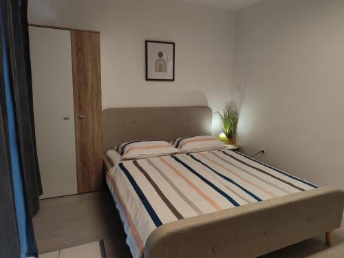 a bed with two pillows in a bedroom at Ivana Apartment in Rabac