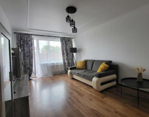 a living room with a couch and a table at Apartment Omāri in Kolka