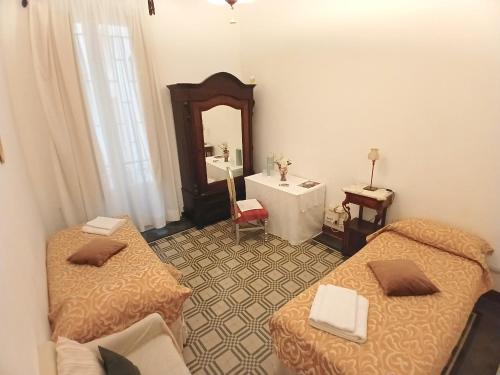 a room with two beds and a sink and a mirror at Guesthouse City Center in Bari