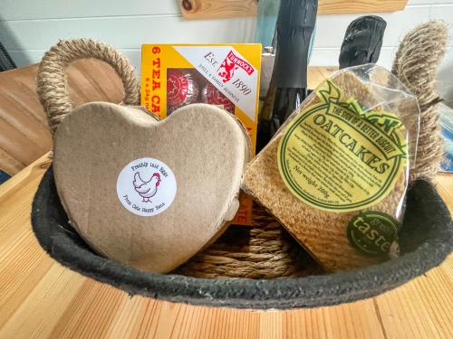 a basket filled with bread and a heart on a table at Duich - Uk50716 in Kirkton