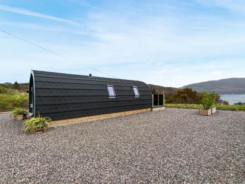 a black house with a black roof at Duich - Uk50716 in Kirkton