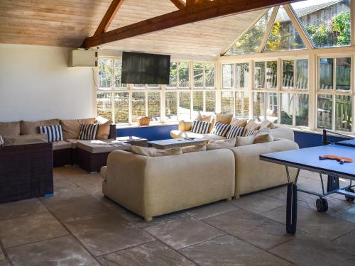 a living room with couches and a flat screen tv at Lily Pad 7 - Uk43916 in Nassington