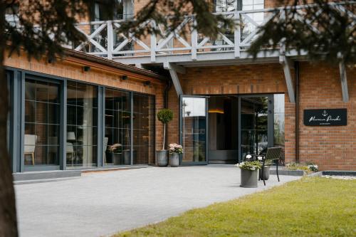 a brick building with a sign in front of it at Marina Piaski Apartamenty in Piaski