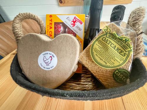 a basket filled with bread and a heart on a table at Totaig - Uk50717 in Kirkton