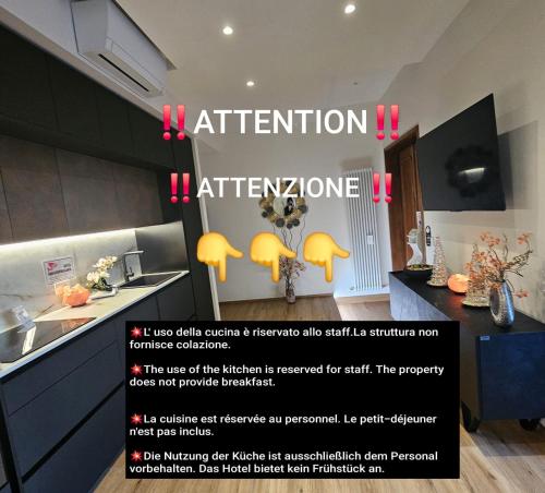 a kitchen with a sign that reads attention attentionalore at Salotto Corso Garibaldi in Piacenza