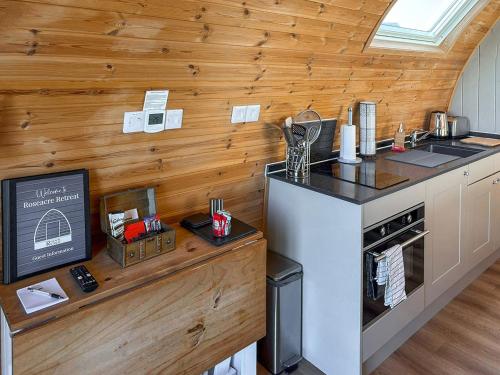 a kitchen with wooden walls and a counter top at The Appleton - Ukc9283 in Brompton