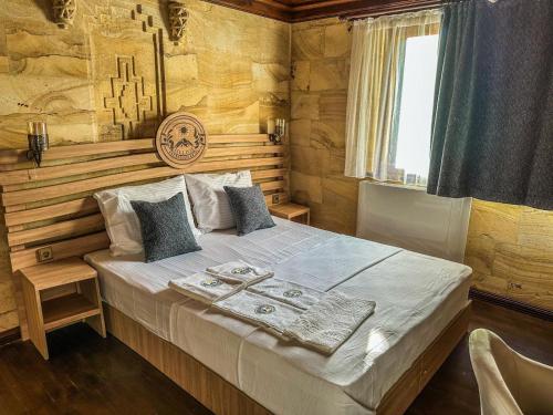 a bedroom with a large bed in a wooden room at Helios Kaz Dağları in Edremit