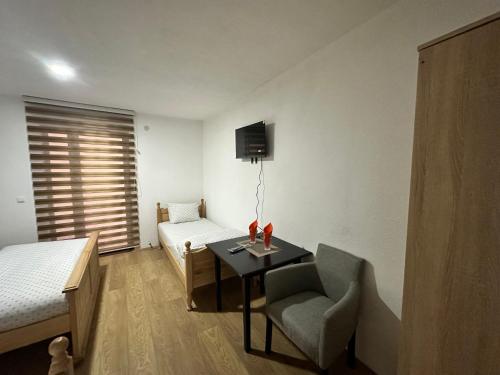 a room with a bed and a table and a chair at Hotel River in Gusinje